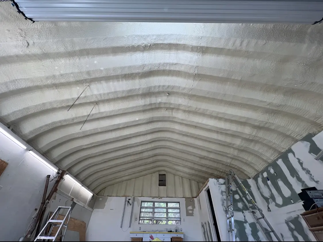 Spray polyurethane foam applied to the underside of a metal roof deck in New Castle
